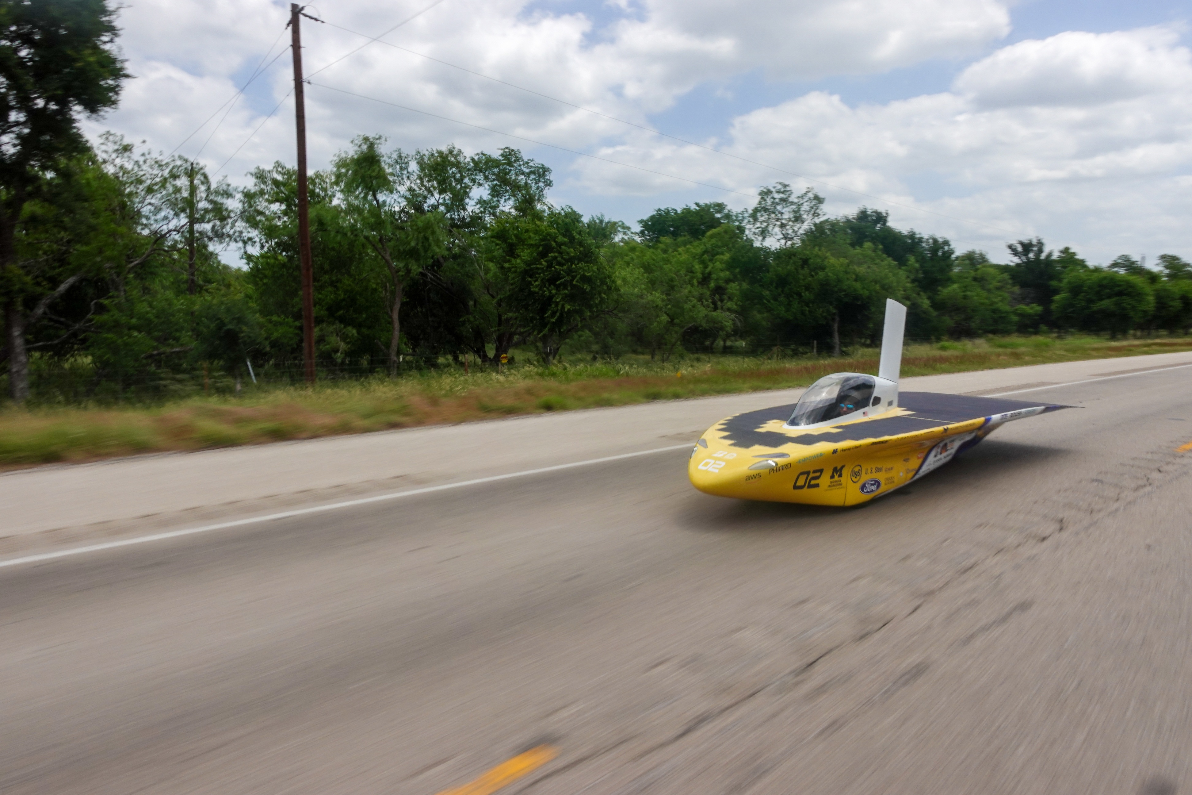 Aikam driving the solar car across the country
